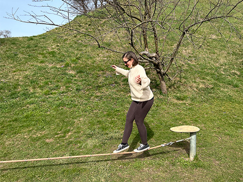 Frau balanciert auf einer Slackline